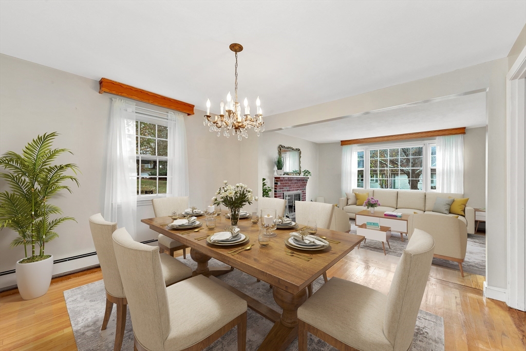 19 Wilbur Avenue Arlington, MA 02476 - Photo 16 of 32 a dining room with wooden floor a chandelier a glass table and chairs