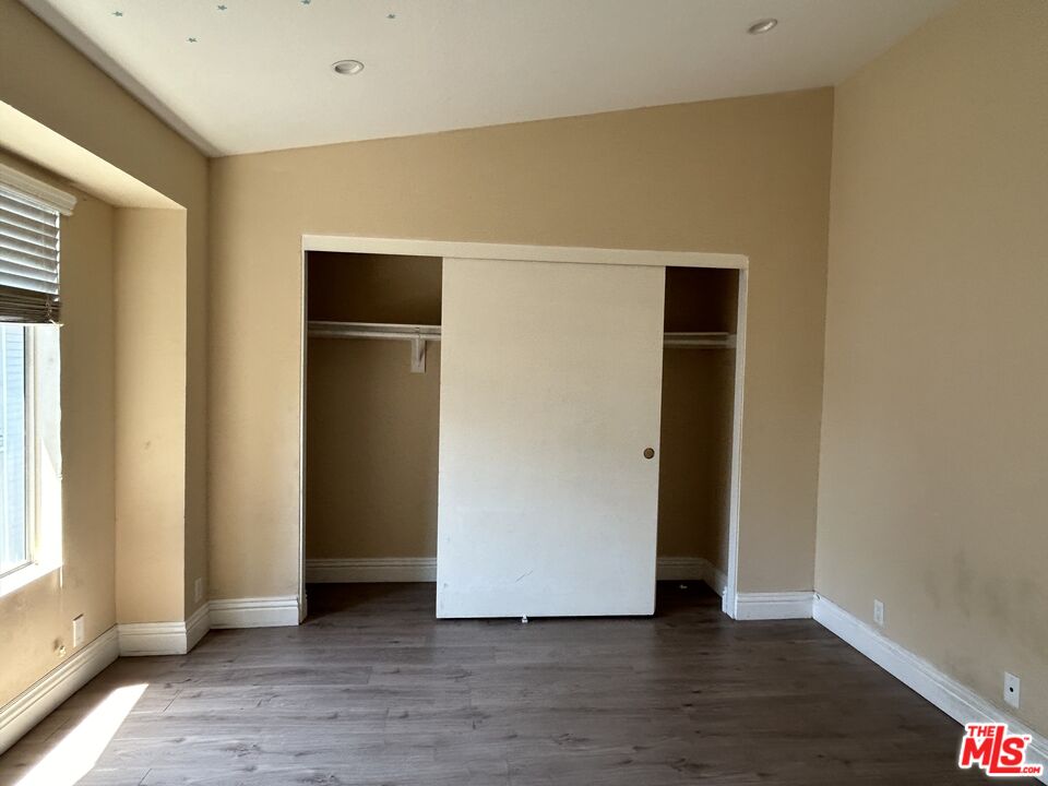 7430 Corbin Avenue, Unit 33 Reseda, CA 91335 - Photo 14 of 28 a view of an empty room with closet and wooden floor