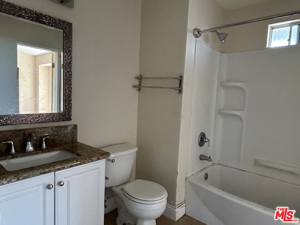 7430 Corbin Avenue, Unit 33 Reseda, CA 91335 - Photo 15 of 28 a bathroom with a granite countertop sink toilet and shower