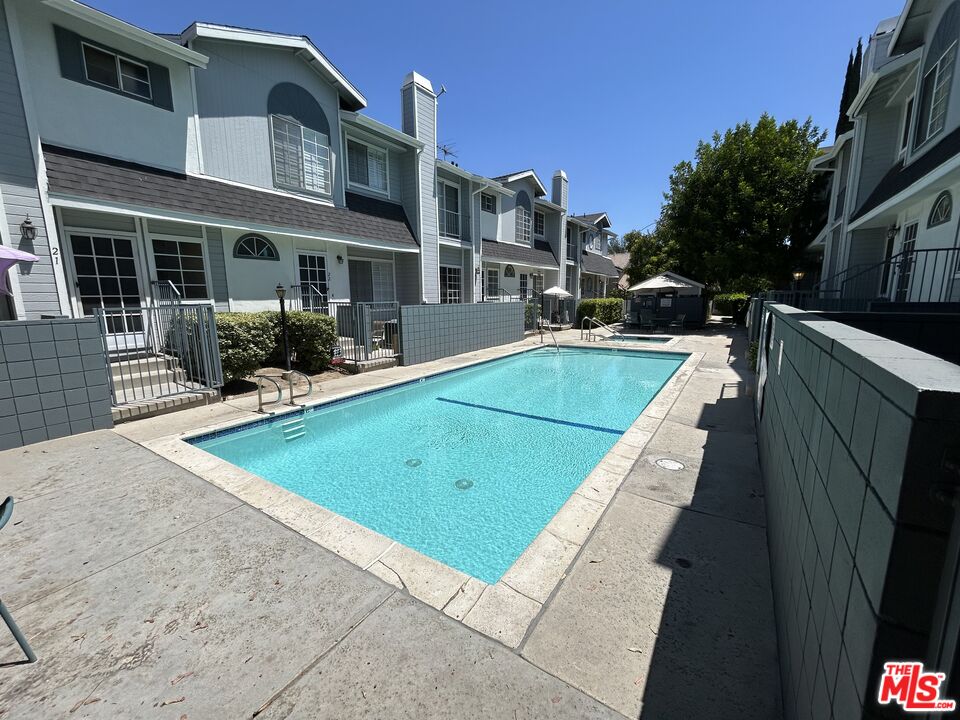 7430 Corbin Avenue, Unit 33 Reseda, CA 91335 - Photo 25 of 28 a view of a patio with swimming pool