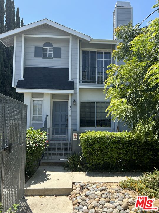 7430 Corbin Avenue, Unit 33 Reseda, CA 91335 - Photo 28 of 28 a front view of a house with garden