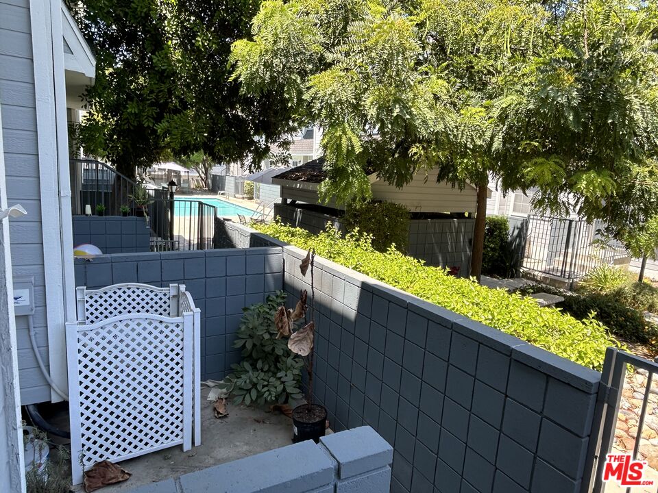7430 Corbin Avenue, Unit 33 Reseda, CA 91335 - Photo 3 of 28 a balcony with wooden floor and outdoor seating