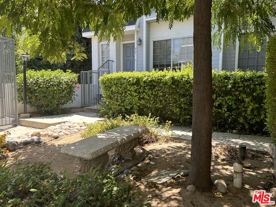 7430 Corbin Avenue, Unit 33 Reseda, CA 91335 - Photo 4 of 28 a view of a yard with plants and wooden fence