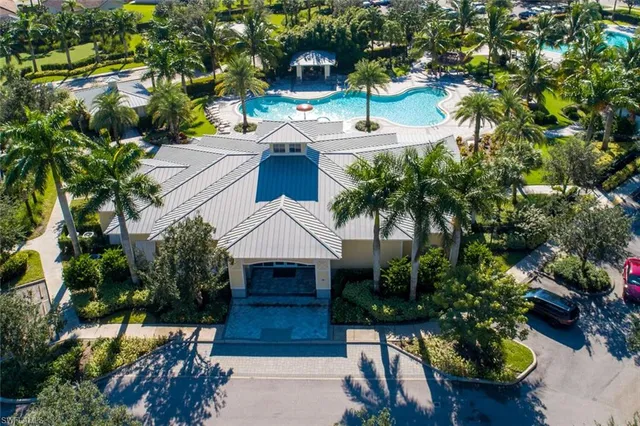 a view of swimming pool with a patio and plants