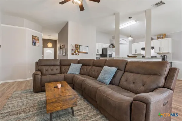 a living room with furniture a fireplace and a flat screen tv