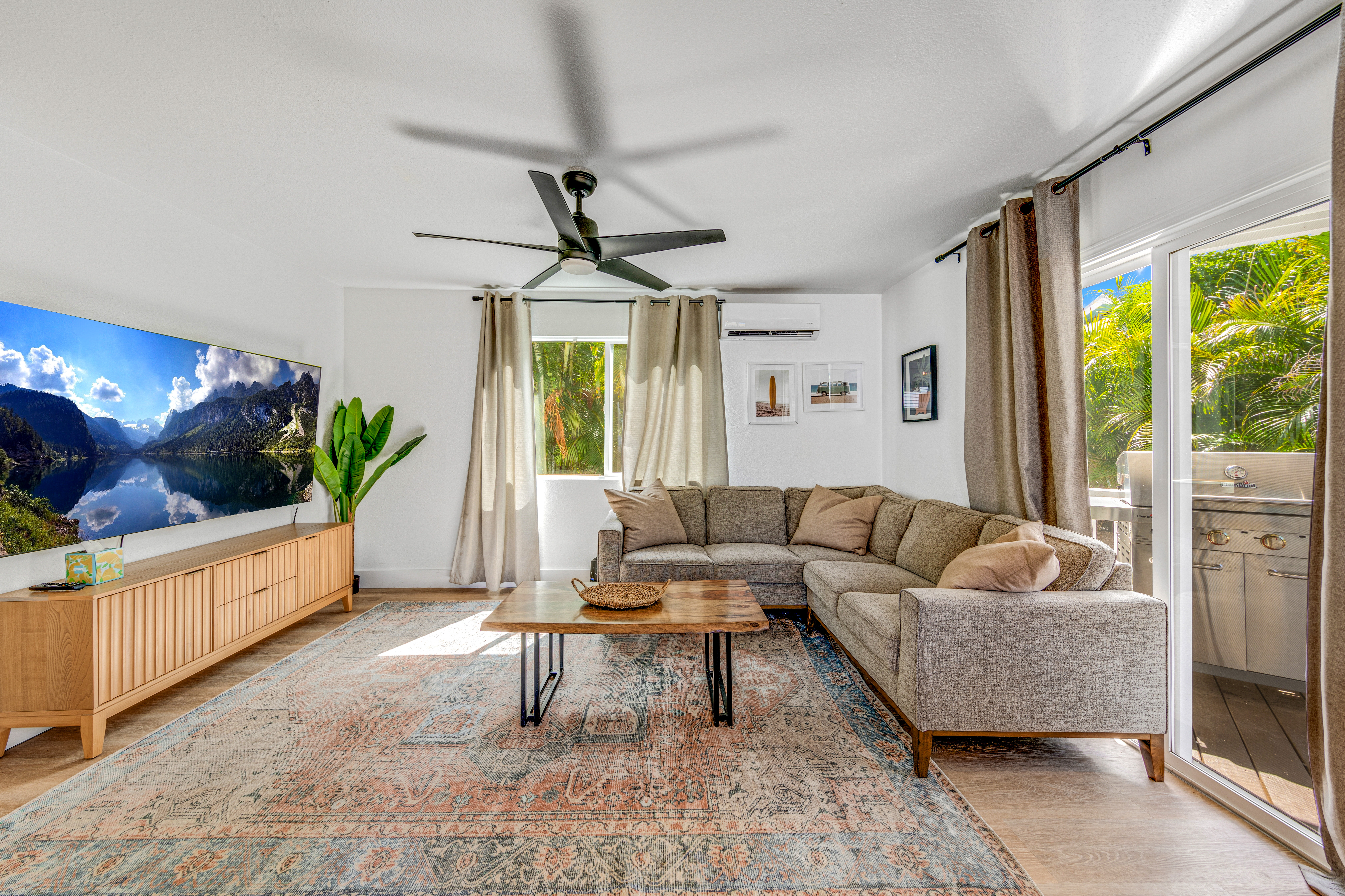 766122 A Royal Poinciana Way, Unit 2 Kailua-Kona, HI 96740 - Photo 11 of 24 a living room with furniture and a large window
