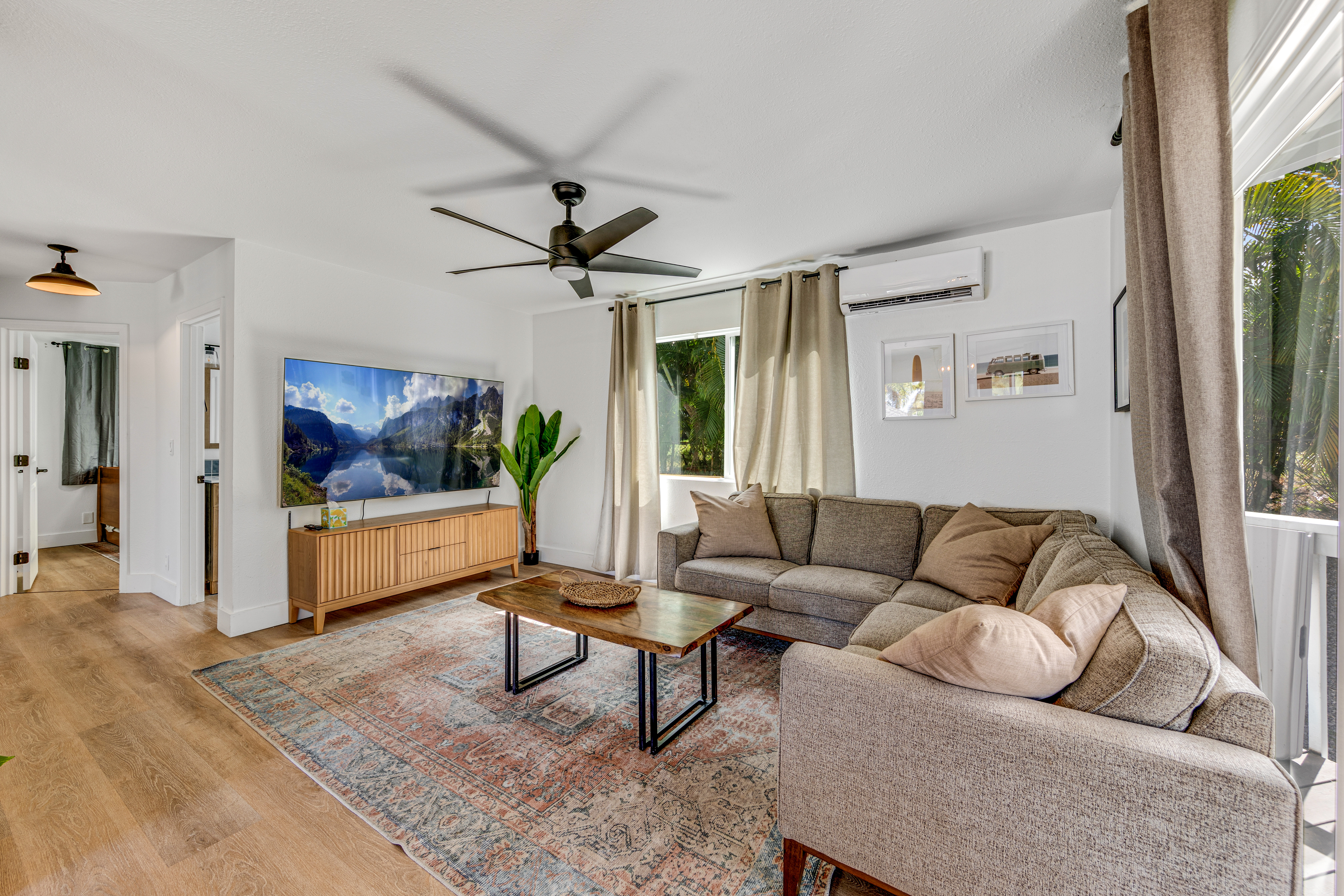 766122 A Royal Poinciana Way, Unit 2 Kailua-Kona, HI 96740 - Photo 12 of 24 a living room with furniture and a flat screen tv
