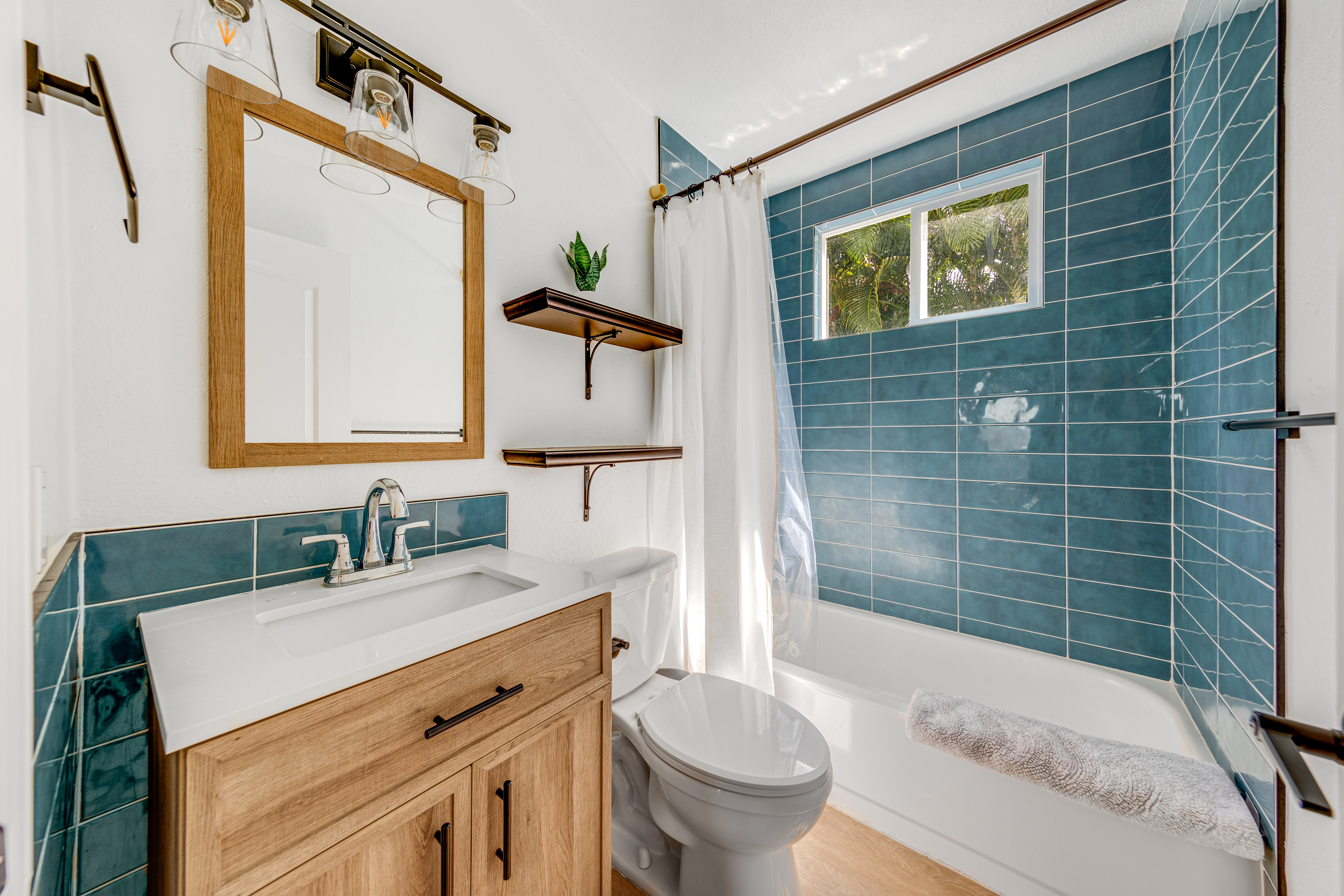 766122 A Royal Poinciana Way, Unit 2 Kailua-Kona, HI 96740 - Photo 13 of 24 a bathroom with a sink toilet and shower