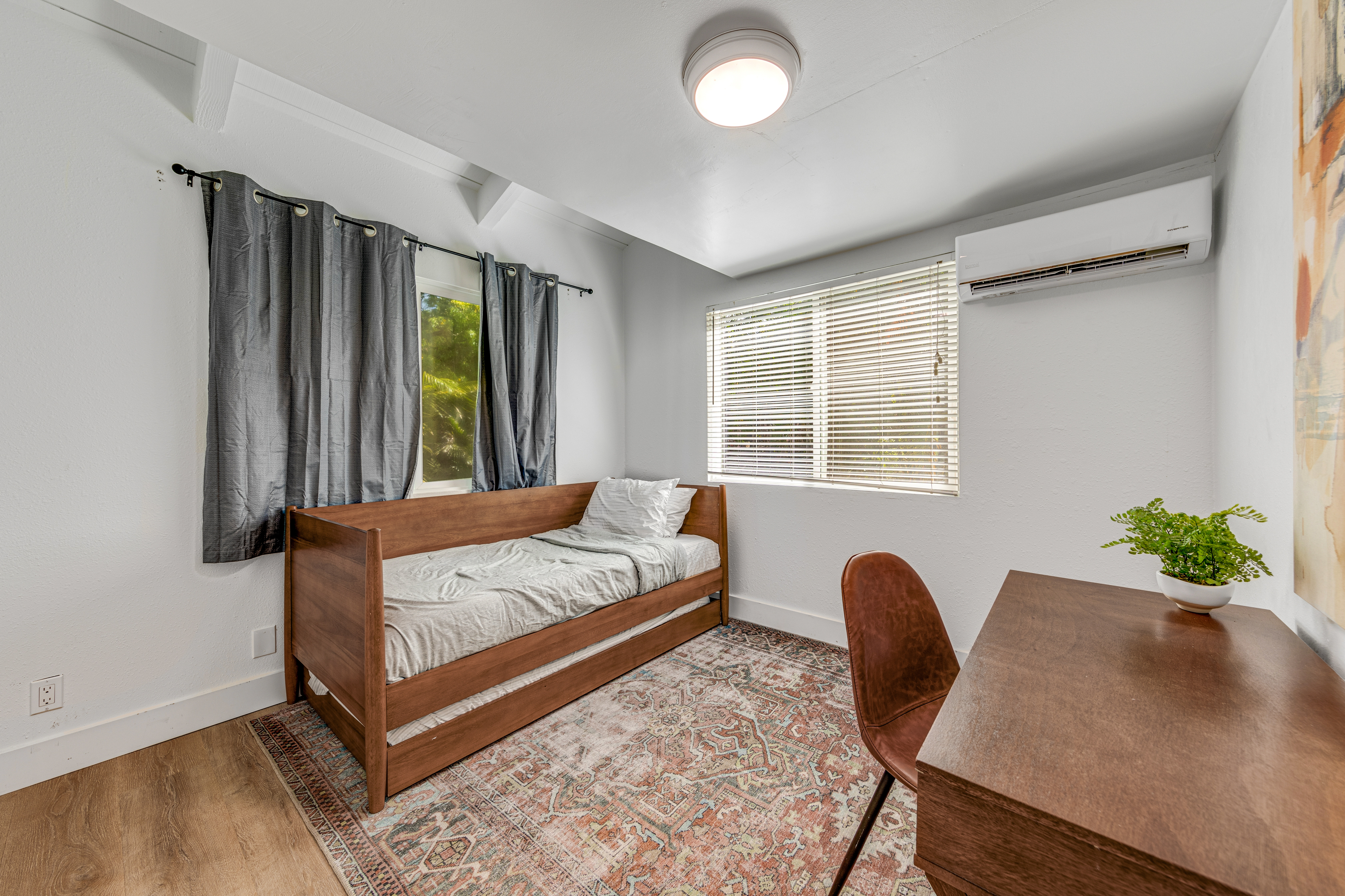 766122 A Royal Poinciana Way, Unit 2 Kailua-Kona, HI 96740 - Photo 14 of 24 a bedroom with a bed lamp and a large window