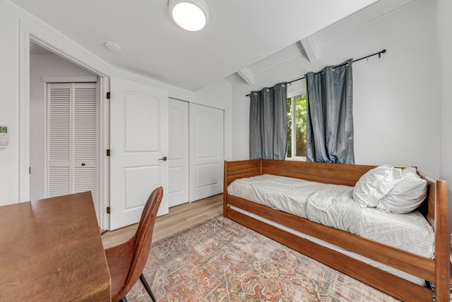 a bedroom with a bed and window