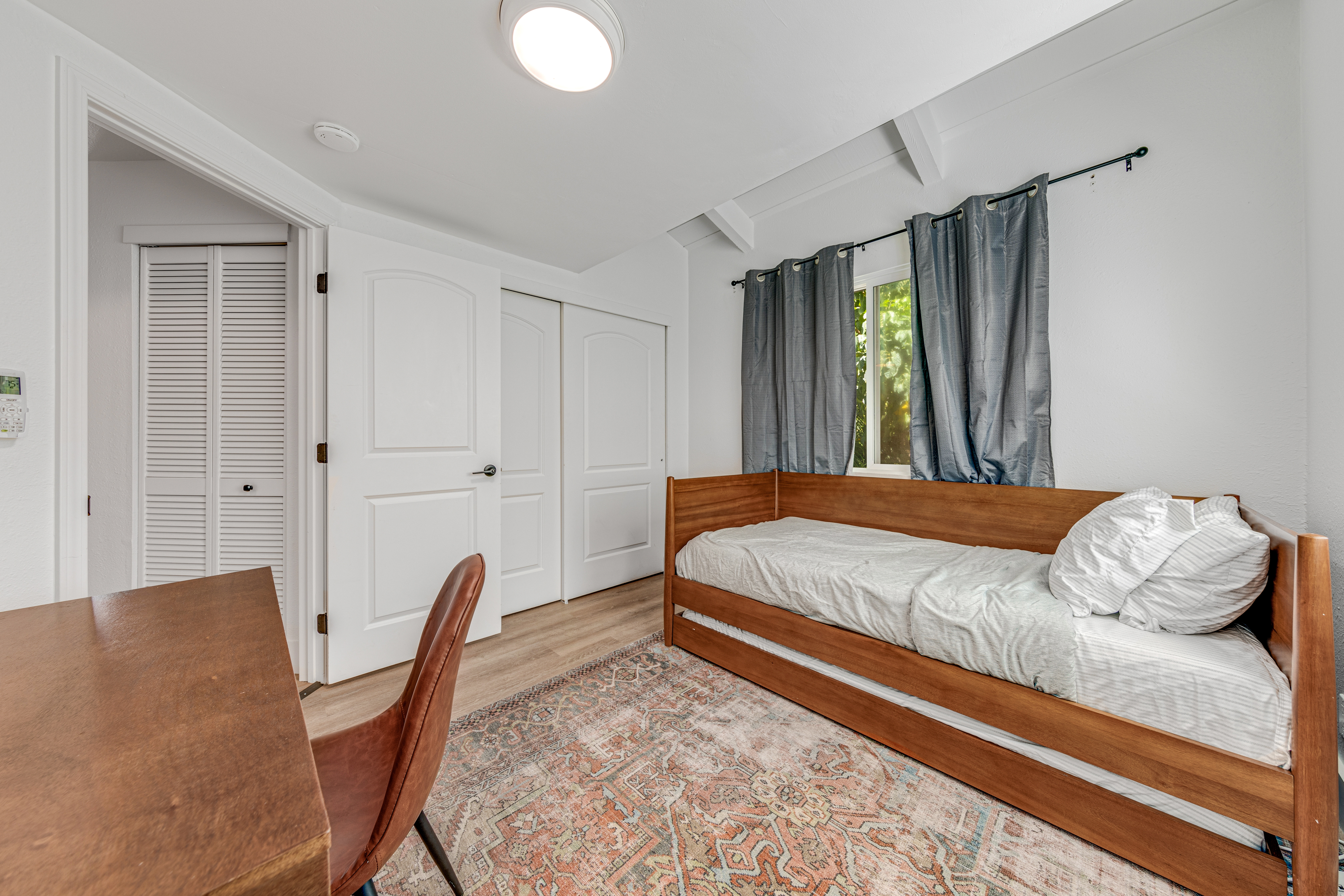 766122 A Royal Poinciana Way, Unit 2 Kailua-Kona, HI 96740 - Photo 15 of 24 a bed sitting in a bedroom next to a window