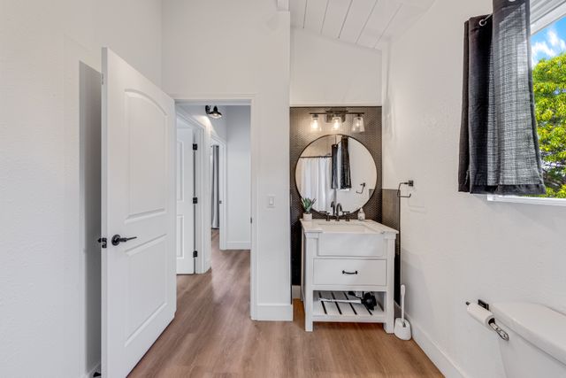 a white toilet sitting next to a bathroom sink