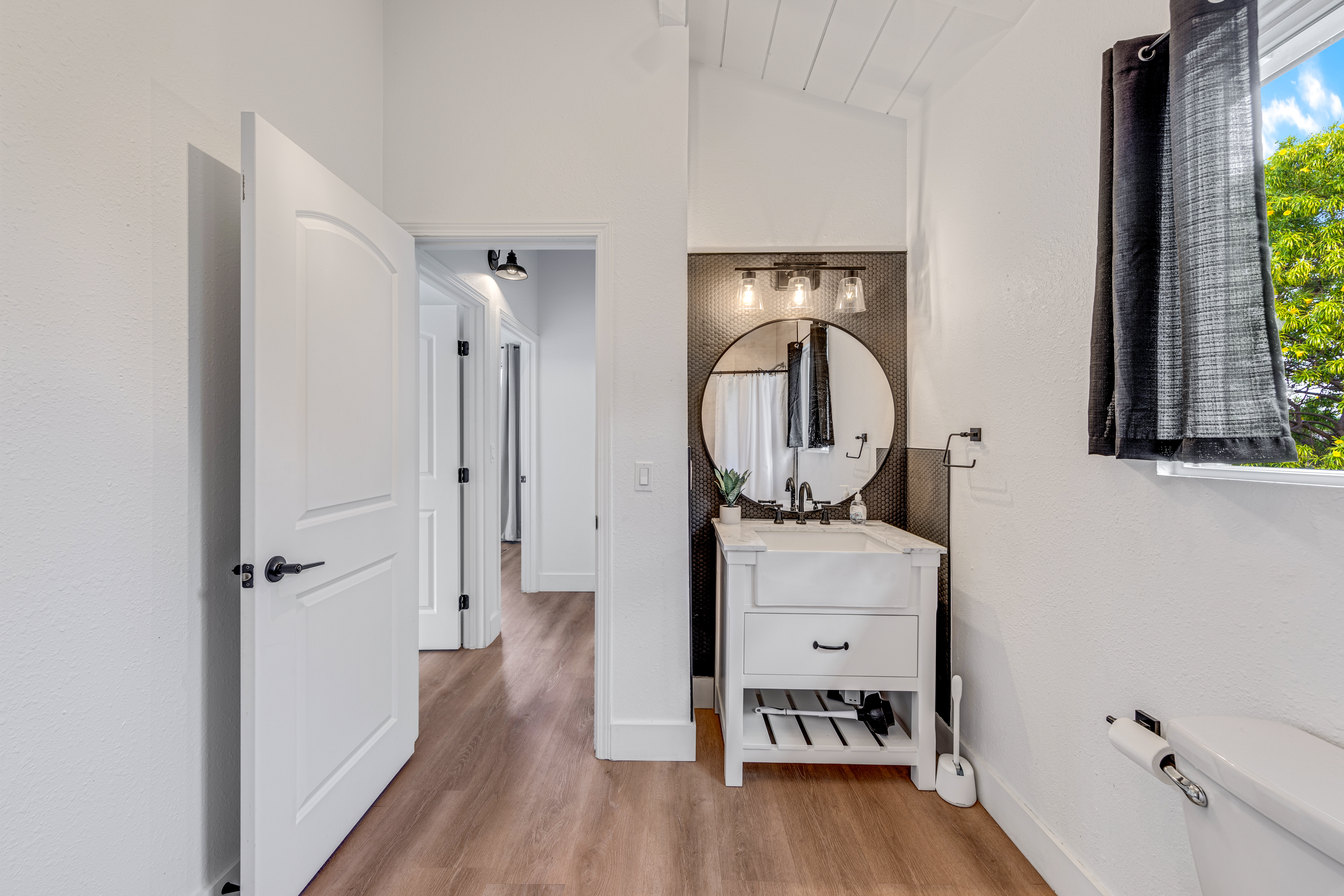 766122 A Royal Poinciana Way, Unit 2 Kailua-Kona, HI 96740 - Photo 19 of 24 a view of a bathroom sink and a mirror
