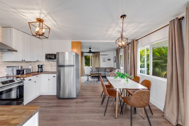 a kitchen with stainless steel appliances granite countertop sink stove and wooden cabinets