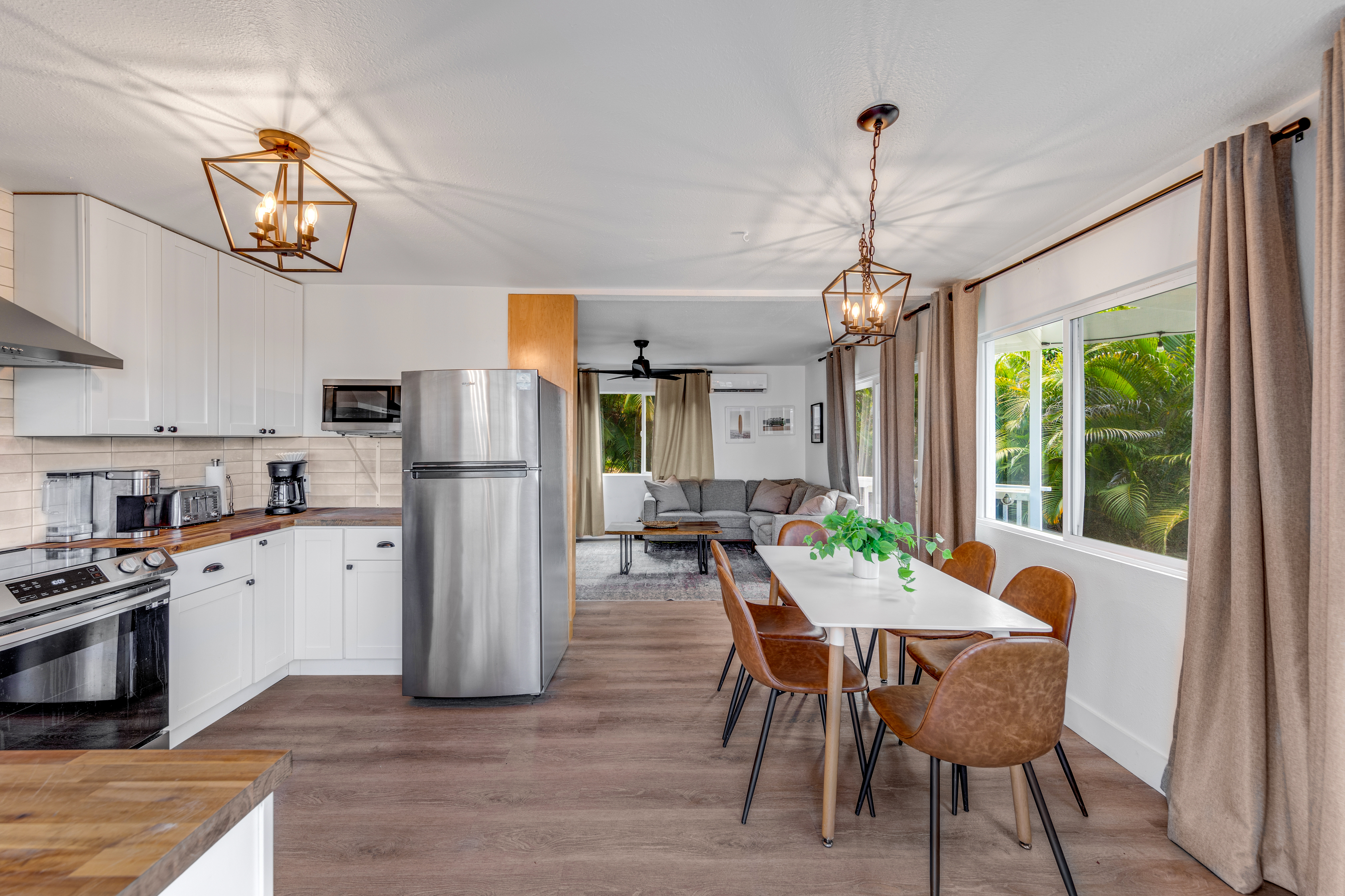 766122 A Royal Poinciana Way, Unit 2 Kailua-Kona, HI 96740 - Photo 7 of 24 a view of a dining room with furniture large window and wooden floor