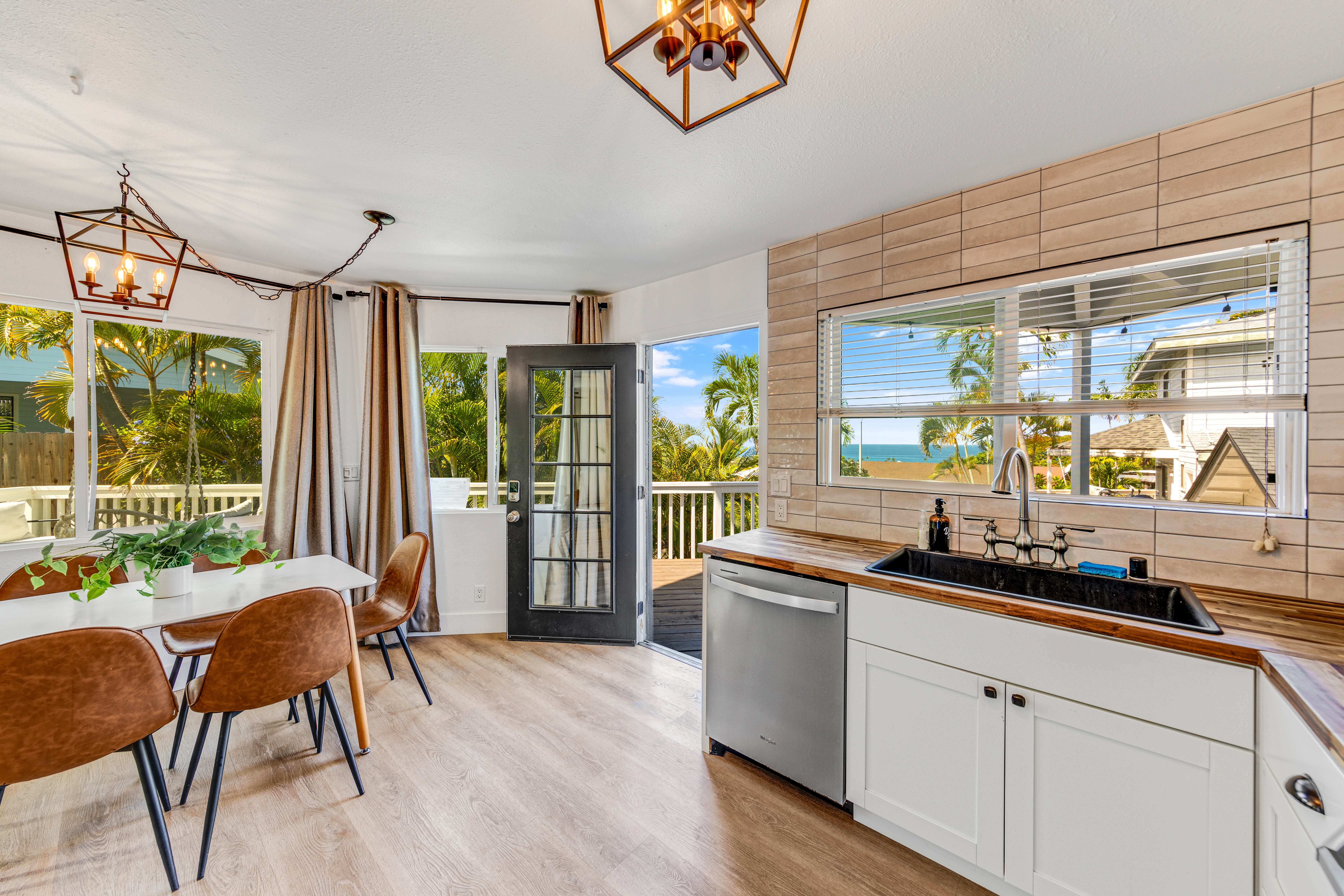 766122 A Royal Poinciana Way, Unit 2 Kailua-Kona, HI 96740 - Photo 8 of 24 a kitchen with stainless steel appliances granite countertop sink stove and wooden cabinets