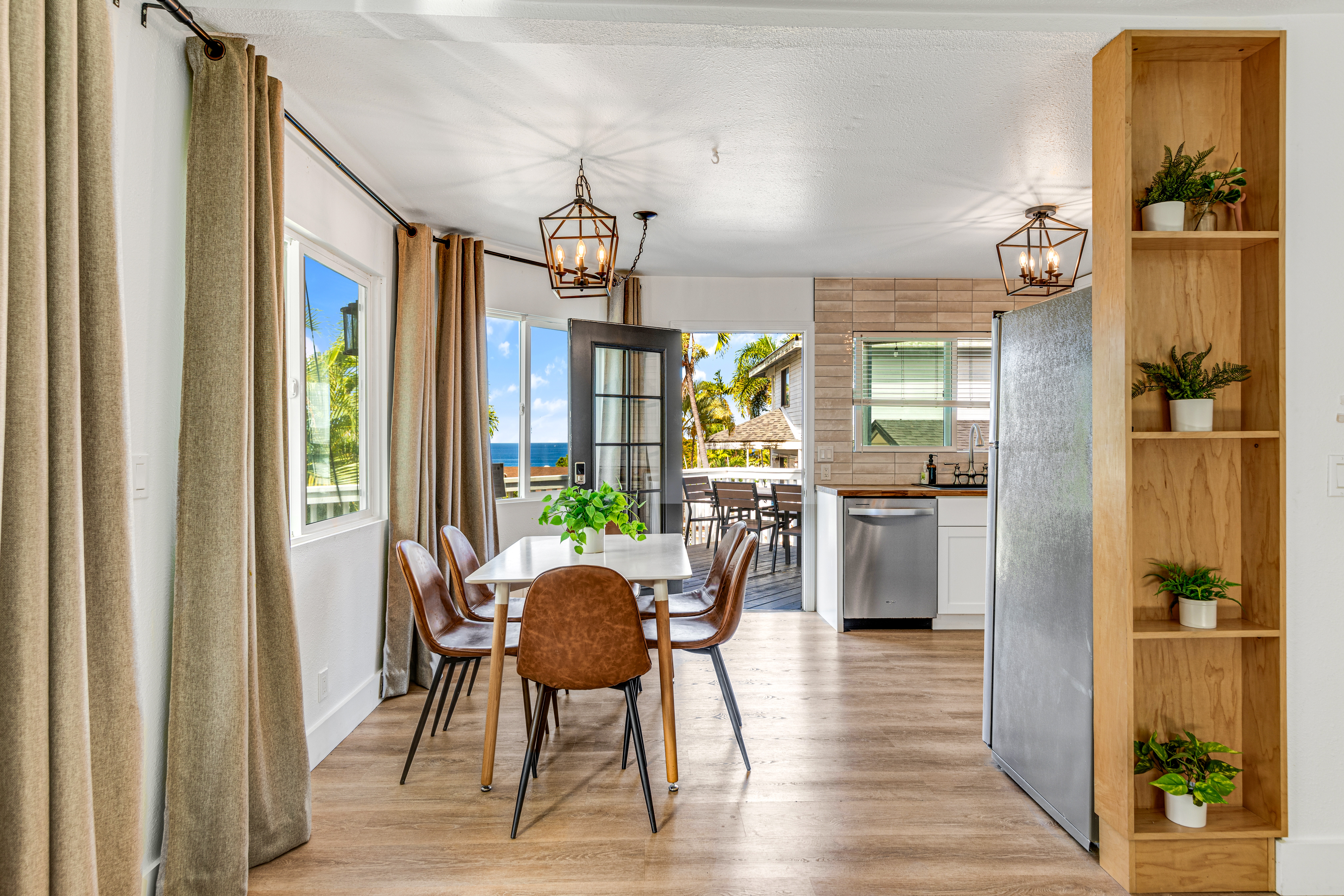 766122 A Royal Poinciana Way, Unit 2 Kailua-Kona, HI 96740 - Photo 9 of 24 a view of a dining room with furniture window and wooden floor