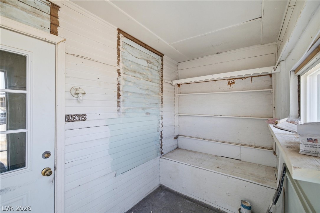 405 Main Street Beatty, NV 89003 - Photo 4 of 28 A quaint enclosed porch offers convenient built-in storage shelves and seating.