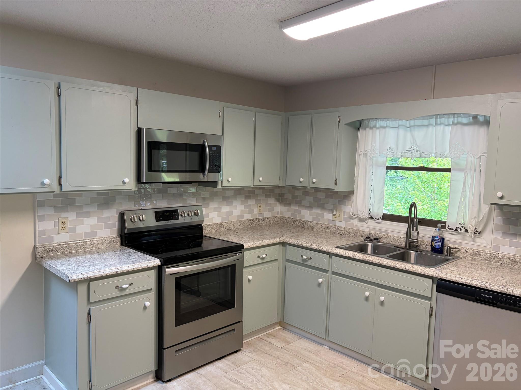 256 A Bruce Road Mars Hill, NC 28754 - Photo 5 of 39 a kitchen with a sink stove and microwave
