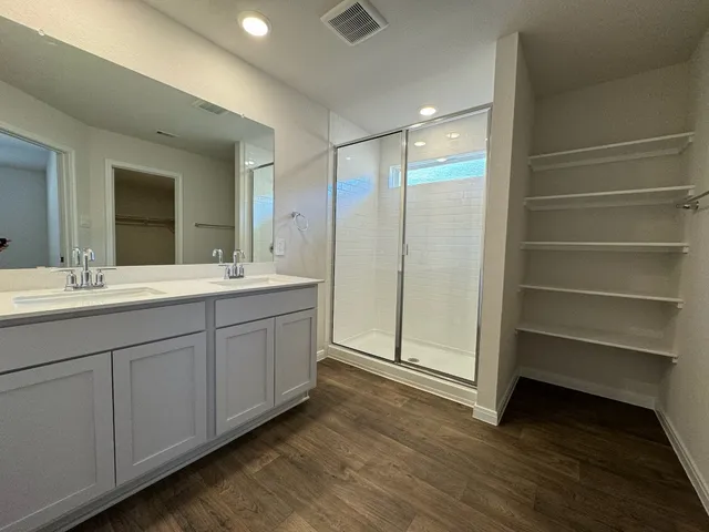 wooden floor in an empty room with a kitchen