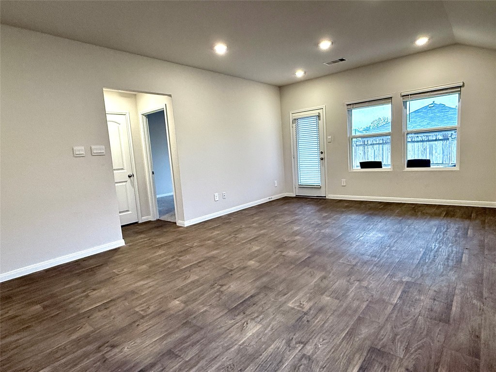 1305 Middleton Grove Lockhart, TX 78644 - Photo 5 of 19 an empty room with wooden floor and windows