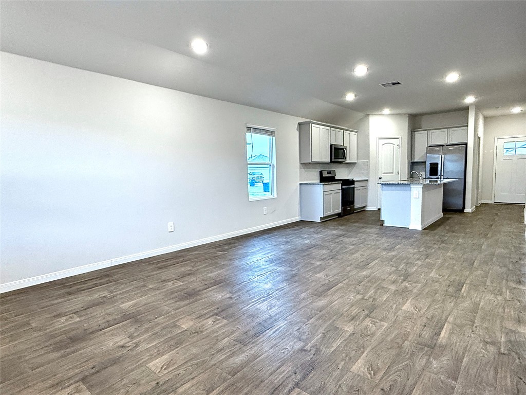 1305 Middleton Grove Lockhart, TX 78644 - Photo 19 of 19 a view of kitchen with microwave oven stove and cabinets