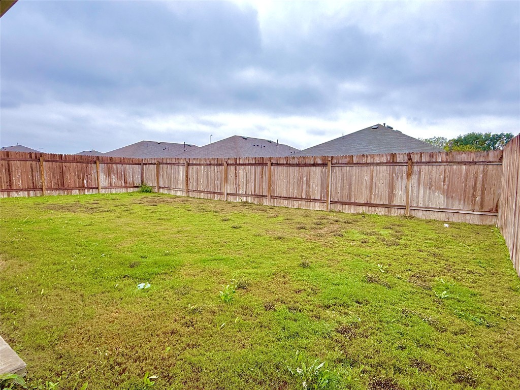 1305 Middleton Grove Lockhart, TX 78644 - Photo 8 of 19 a view of a yard with a large tree and wooden fence