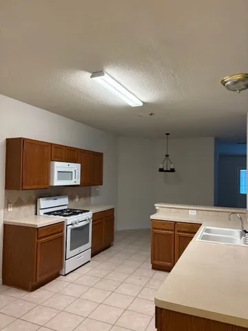 a kitchen with stainless steel appliances a stove top oven and sink