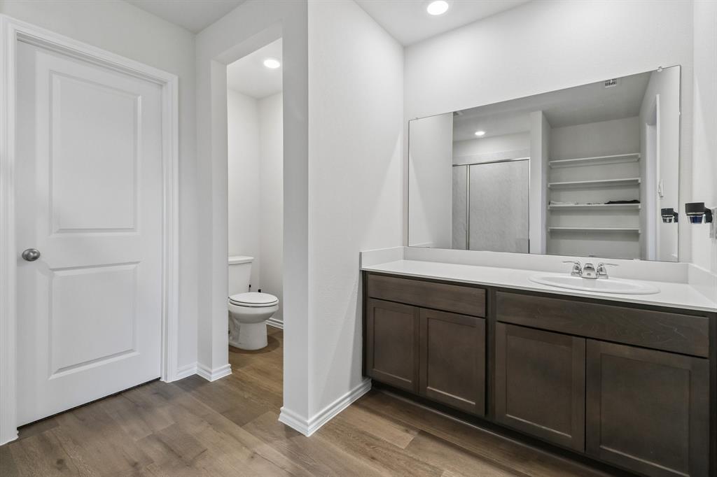 1453 Millstead Rill Road Caddo Mills, TX 75135 - Photo 32 of 40 Spacious vanity with dark wood-finish cabinetry and a light-toned countertop