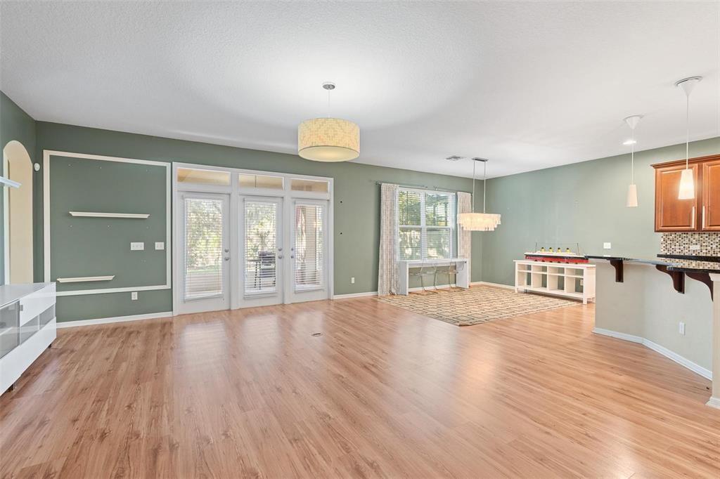 6799 Helmsley Circle Windermere, FL 34786 - Photo 15 of 61 a view of an empty room with wooden floor and a window
