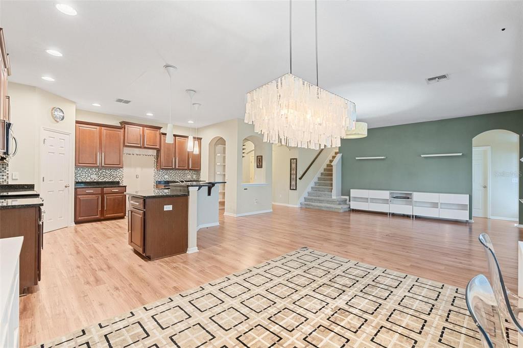 6799 Helmsley Circle Windermere, FL 34786 - Photo 18 of 61 a open kitchen with stainless steel appliances kitchen island granite countertop a refrigerator a stove a sink dishwasher and a wooden cabinets
