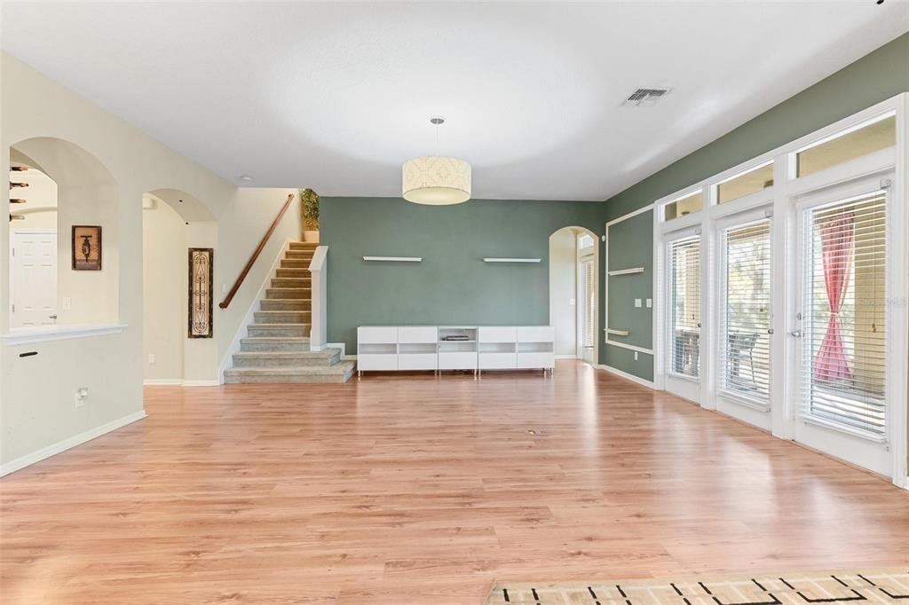 6799 Helmsley Circle Windermere, FL 34786 - Photo 19 of 61 a view of an empty room with wooden floor and a window