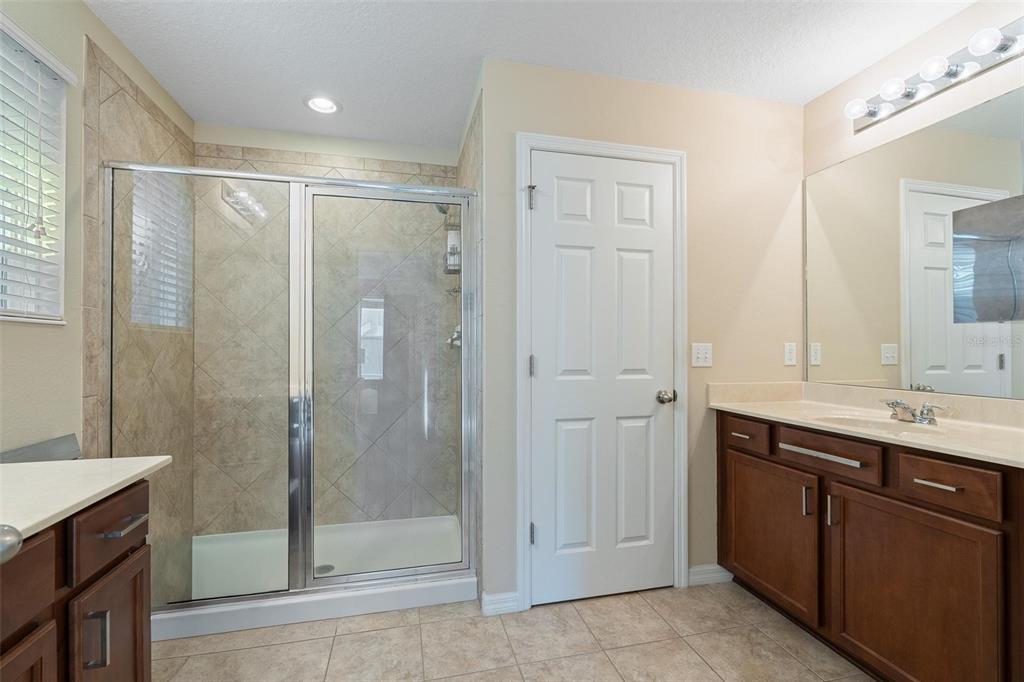 6799 Helmsley Circle Windermere, FL 34786 - Photo 28 of 61 a bathroom with a shower sink and mirror
