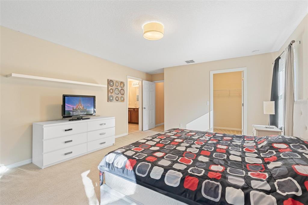 6799 Helmsley Circle Windermere, FL 34786 - Photo 31 of 61 a bedroom with a bed and a dresser