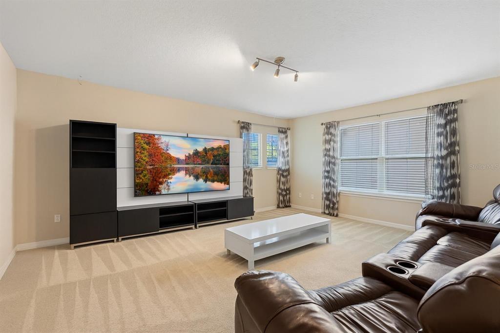 6799 Helmsley Circle Windermere, FL 34786 - Photo 38 of 61 a living room with furniture and a flat screen tv