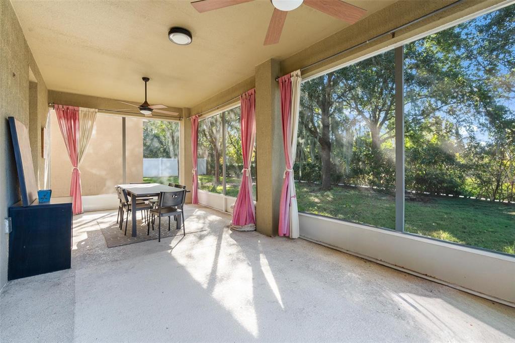 6799 Helmsley Circle Windermere, FL 34786 - Photo 42 of 61 a view of a porch with furniture and a yard