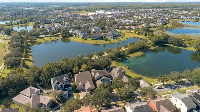 an aerial view of a house with a swimming pool and garden