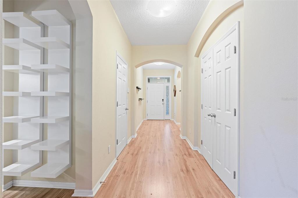 6799 Helmsley Circle Windermere, FL 34786 - Photo 9 of 61 a view of a hallway with wooden floor and a bathroom