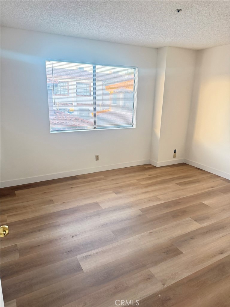 816 North Garfield Avenue, Unit B Alhambra, CA 91801 - Photo 5 of 12 a view of an empty room with wooden floor and a window
