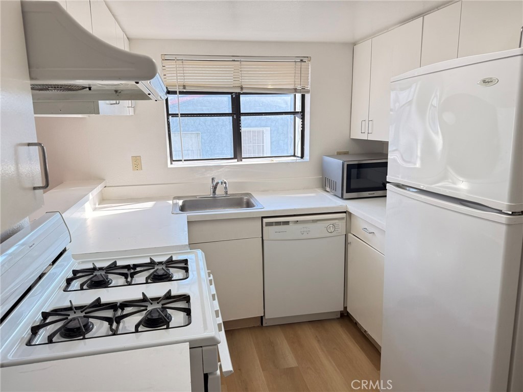816 North Garfield Avenue, Unit B Alhambra, CA 91801 - Photo 10 of 12 a kitchen with a sink a stove and white cabinets