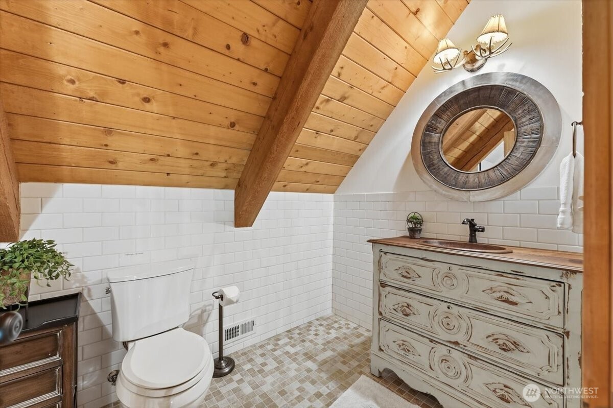 2250 First Crk Road Chelan, WA 98816 - Photo 26 of 39 a bathroom with a toilet a sink and mirror