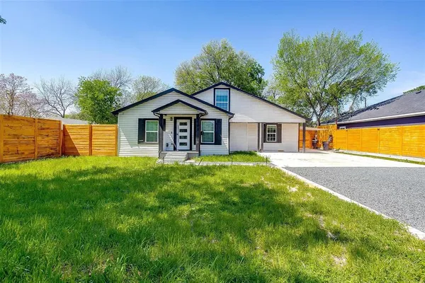 a house with green field in front of it