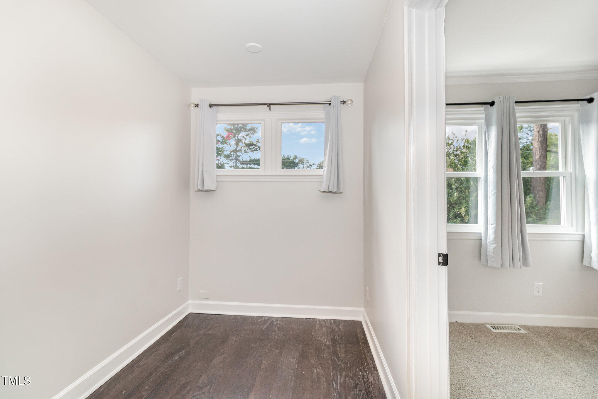 7050 Sandy Forks Road, Unit 101 Raleigh, NC 27615 - Photo 11 of 23 an empty room with wooden floor and windows