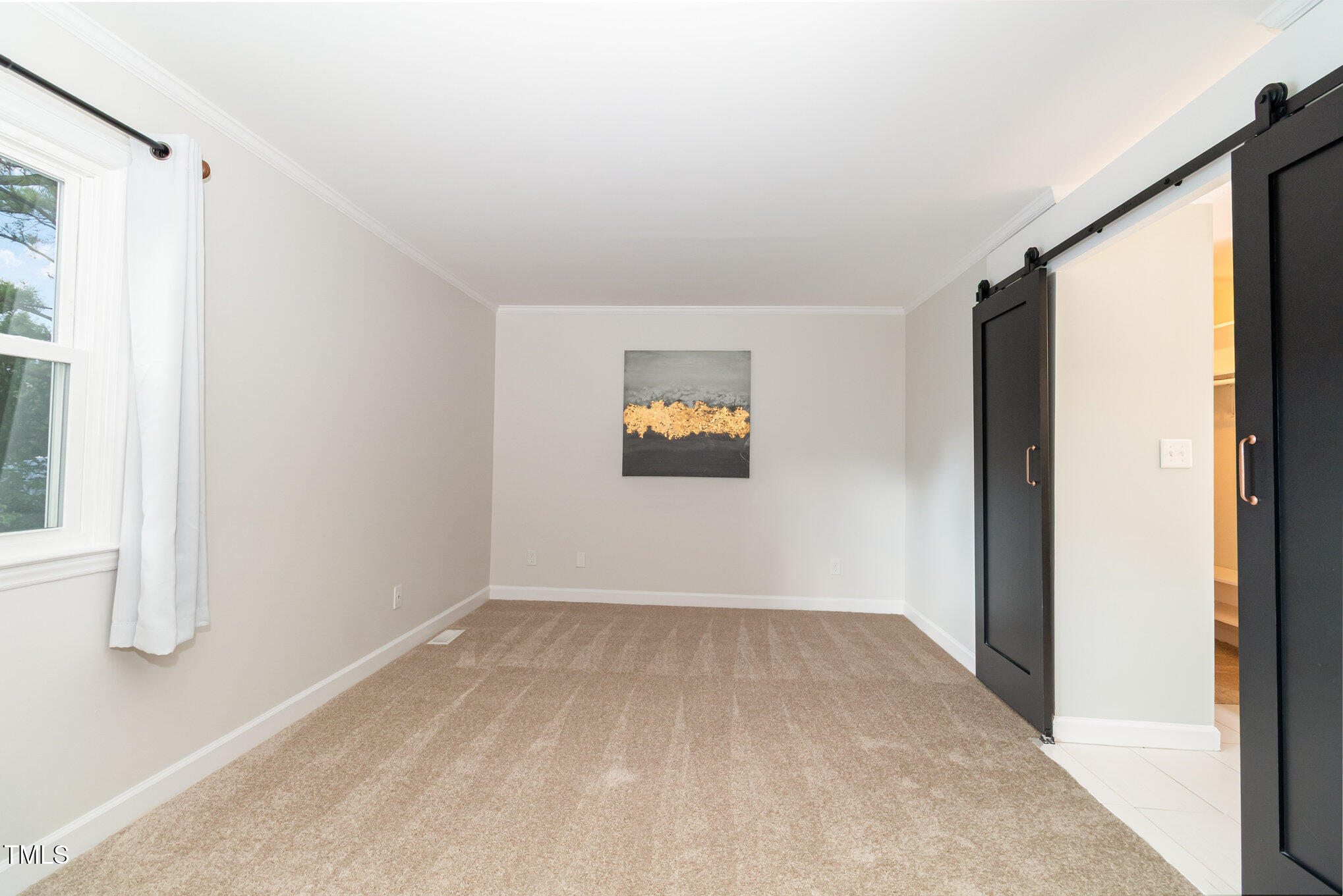 7050 Sandy Forks Road, Unit 101 Raleigh, NC 27615 - Photo 12 of 23 a view of a big room with wooden floor and windows