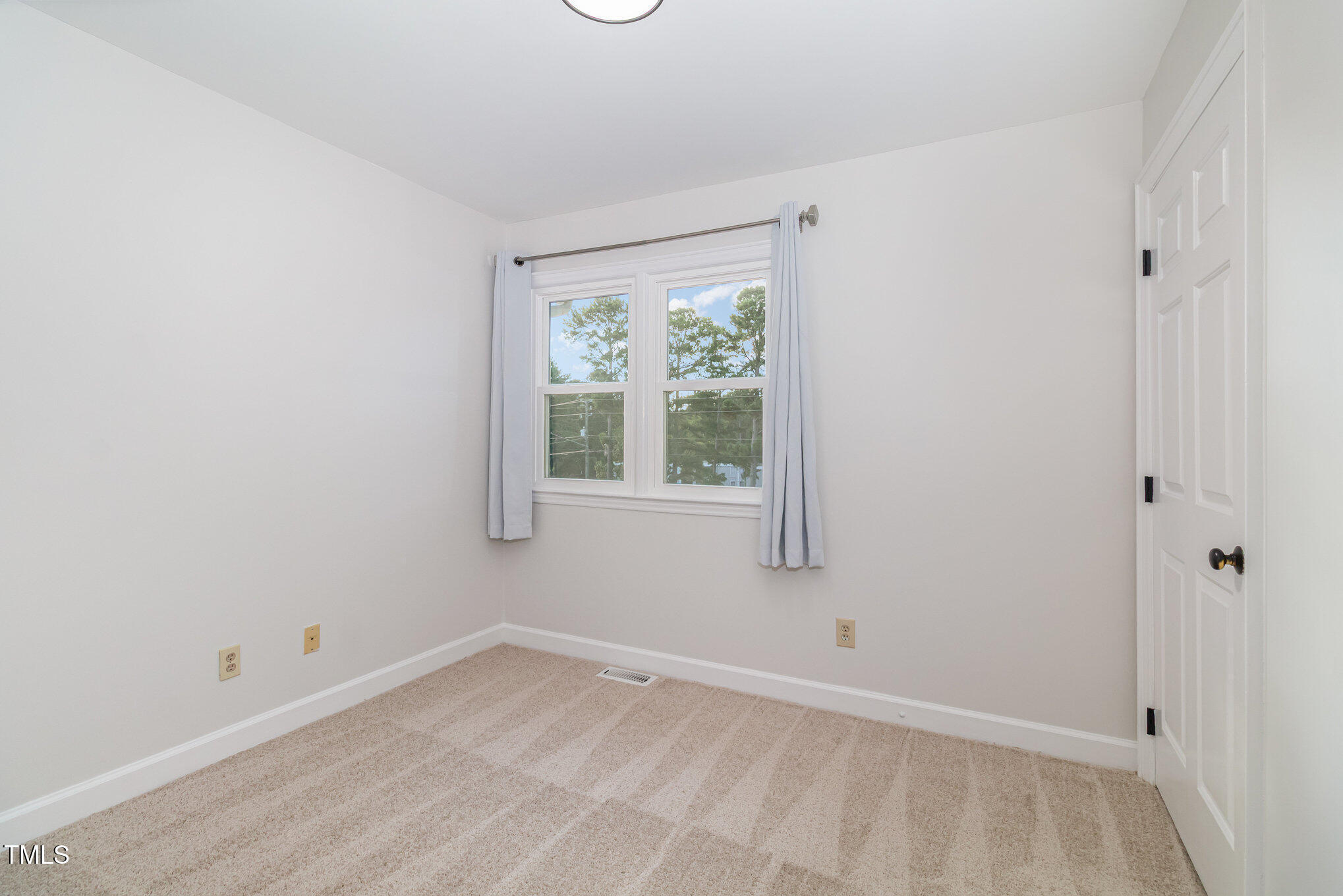 7050 Sandy Forks Road, Unit 101 Raleigh, NC 27615 - Photo 16 of 23 a view of an empty room with a window
