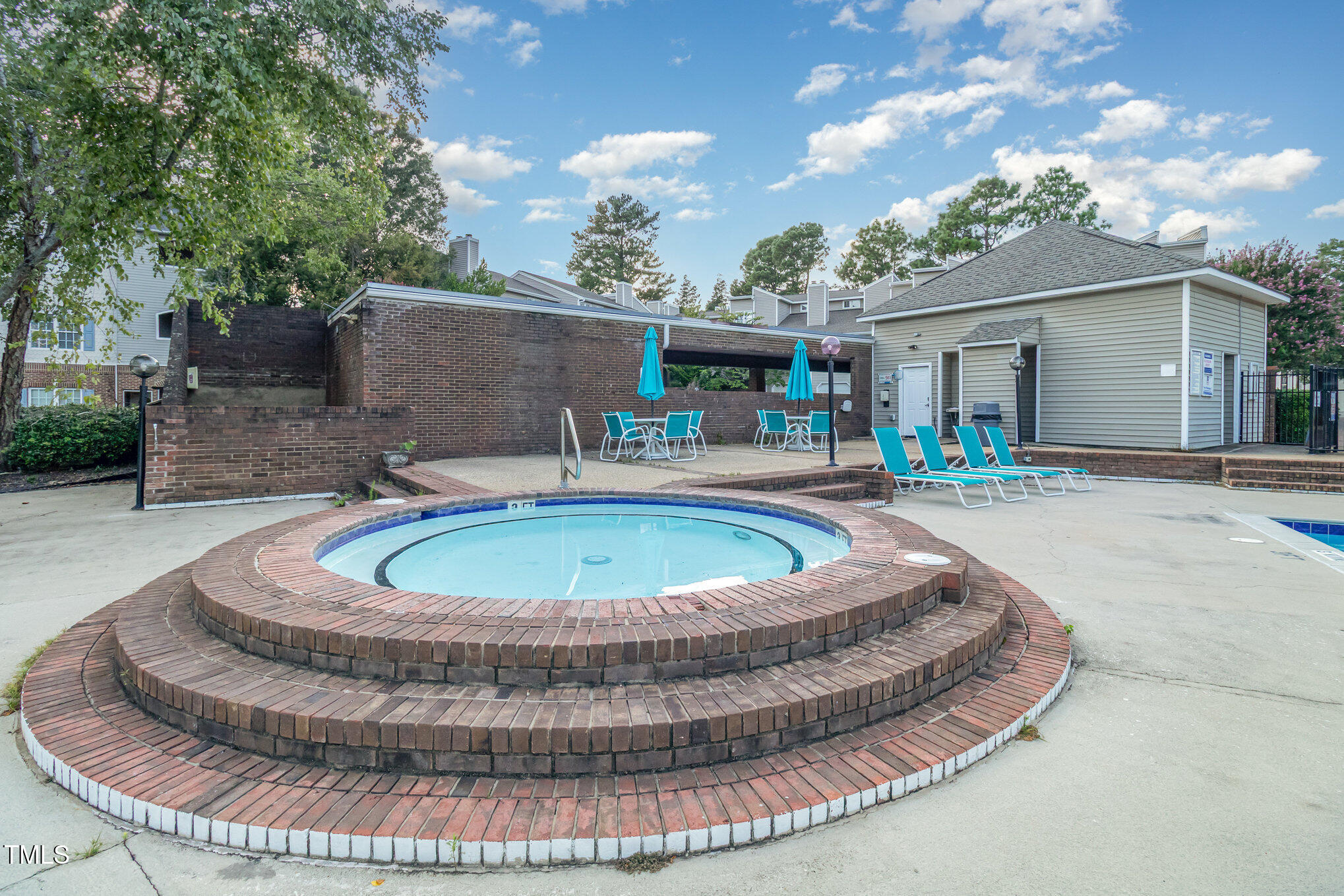 7050 Sandy Forks Road, Unit 101 Raleigh, NC 27615 - Photo 21 of 23 a view of a house with swimming pool and sitting area