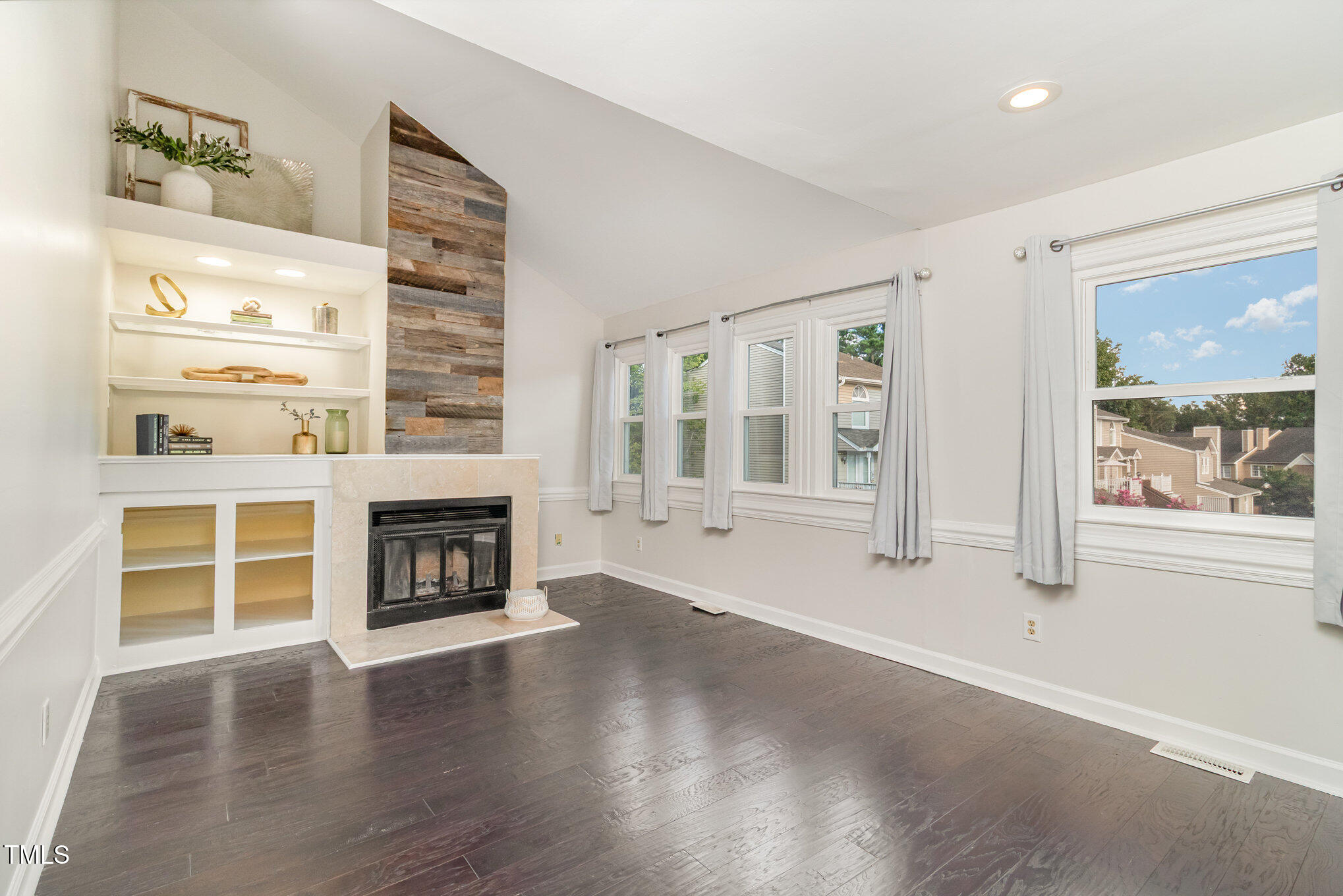 7050 Sandy Forks Road, Unit 101 Raleigh, NC 27615 - Photo 4 of 23 wooden floor fireplace and windows in an empty room