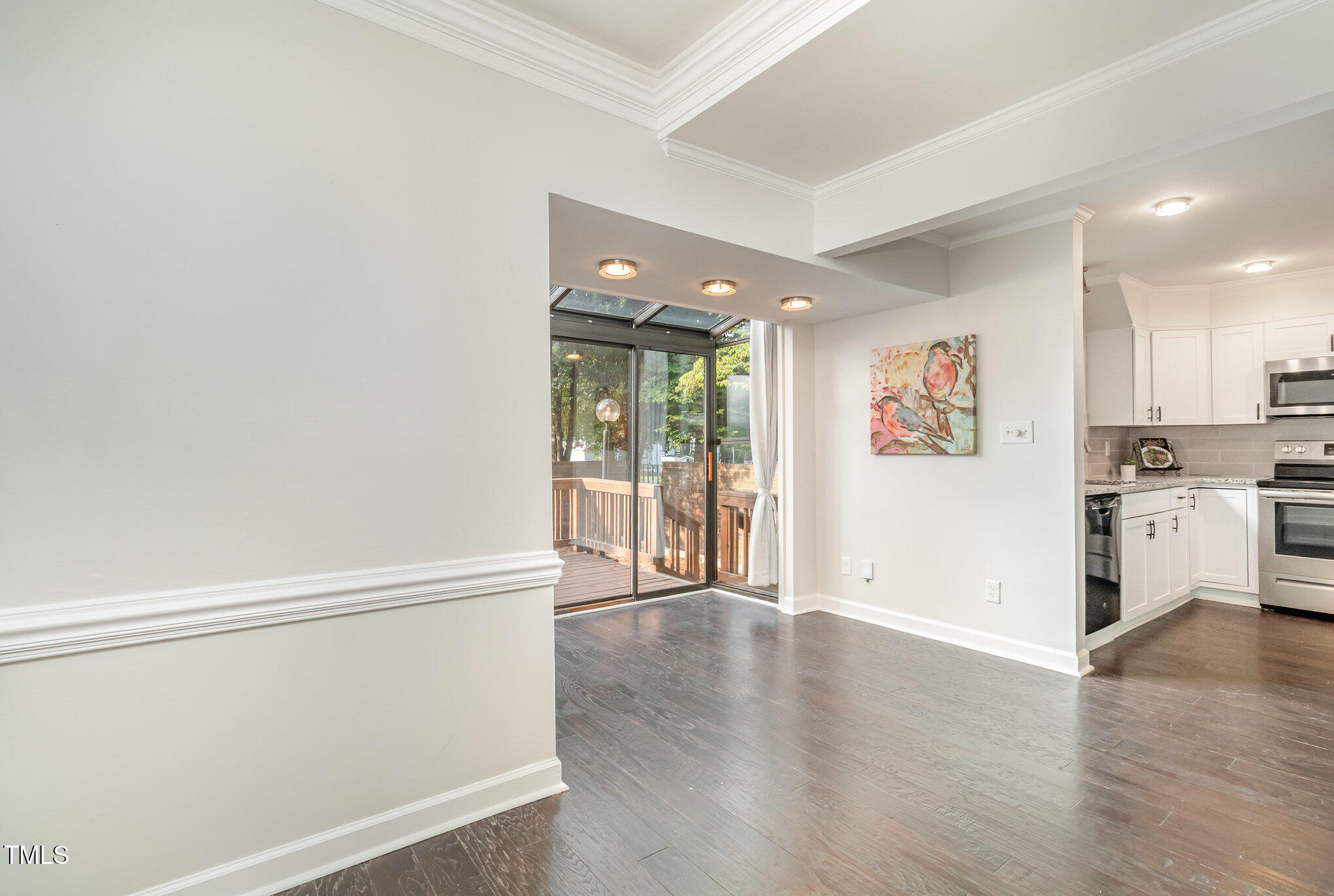 7050 Sandy Forks Road, Unit 101 Raleigh, NC 27615 - Photo 5 of 23 a view of a kitchen with wooden floor and electronic appliances