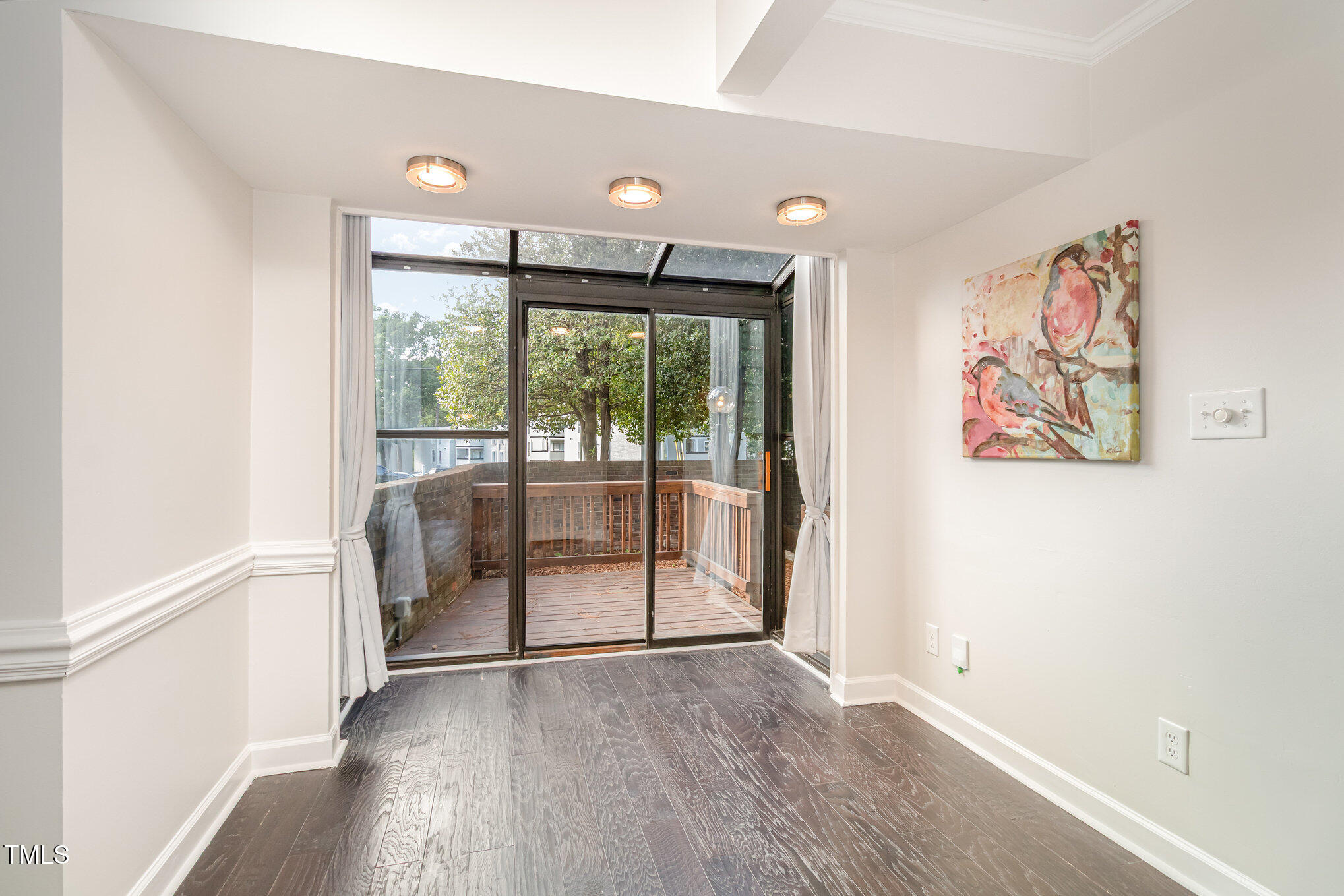 7050 Sandy Forks Road, Unit 101 Raleigh, NC 27615 - Photo 6 of 23 wooden floor in an empty room with a window