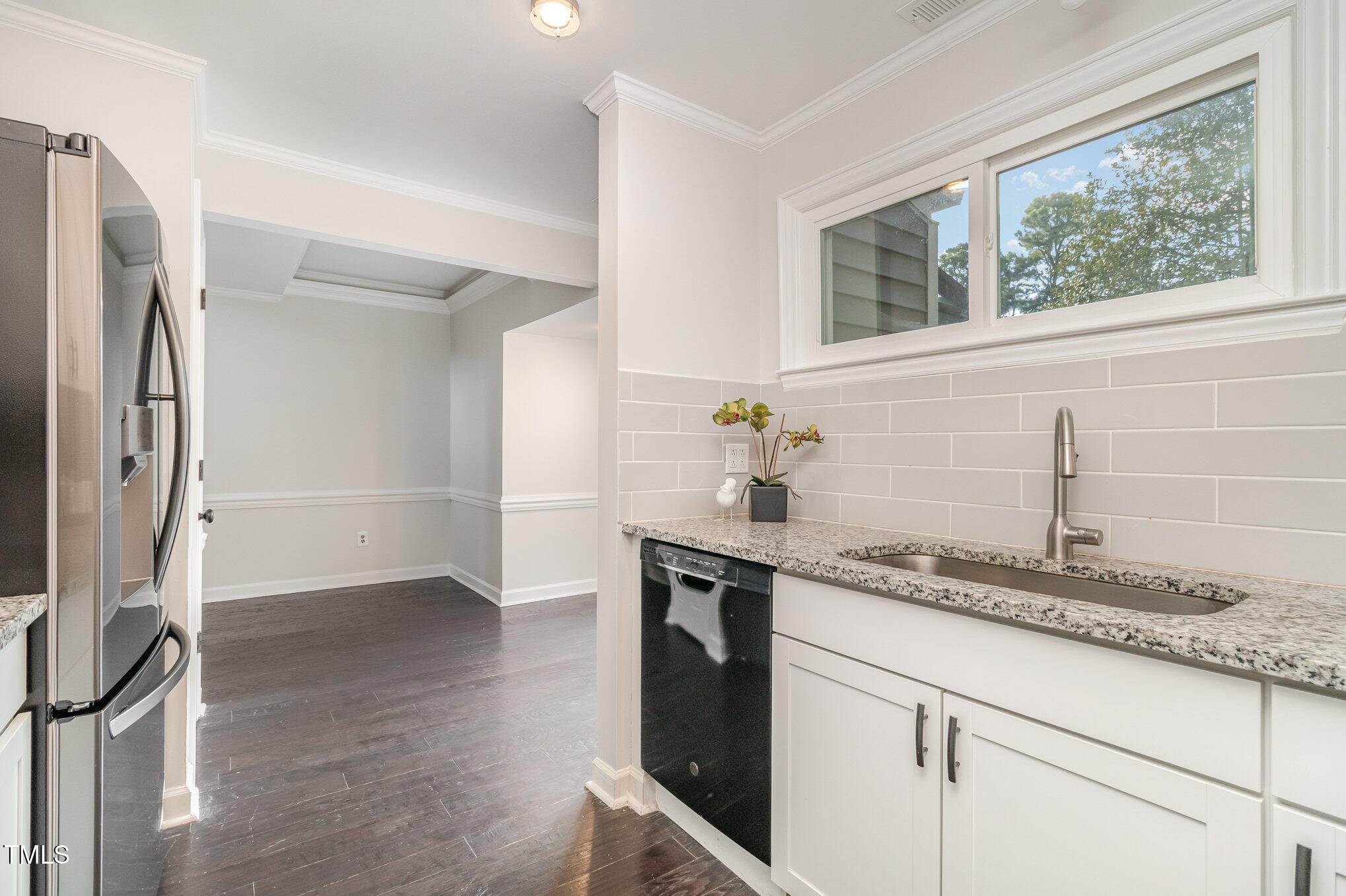 7050 Sandy Forks Road, Unit 101 Raleigh, NC 27615 - Photo 8 of 23 a kitchen with granite countertop a sink stainless steel appliances and cabinets
